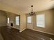 Dining area featuring wood-look floors, bright windows, and modern lighting at 132 Peggy Meadows Way, Douglasville, GA 30134