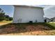 View of the side of the house, with light siding and well-maintained lawn at 132 Peggy Meadows Way, Douglasville, GA 30134