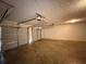 Spacious garage with multiple garage doors and a concrete floor at 132 Peggy Meadows Way, Douglasville, GA 30134