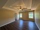 Main bedroom with trey ceiling, fan, and wood-look floors at 132 Peggy Meadows Way, Douglasville, GA 30134