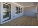 Elegant back porch features wood flooring, white trim, and a glass door entry to the home at 1996 Deco Dr, Kennesaw, GA 30144