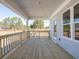 Spacious back porch boasts wood flooring, stylish railings, and views of the yard at 1996 Deco Dr, Kennesaw, GA 30144
