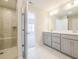 Modern bathroom featuring a glass enclosed shower, marble floors and double vanity at 1996 Deco Dr, Kennesaw, GA 30144