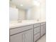 Bright bathroom featuring double sinks and grey cabinetry at 1996 Deco Dr, Kennesaw, GA 30144