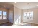 Dining room featuring wood floors, neutral walls, a chandelier and a large window at 1996 Deco Dr, Kennesaw, GA 30144