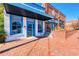 Delightful white brick building with bright blue trim, a brick patio, and decorative landscaping at 1996 Deco Dr, Kennesaw, GA 30144