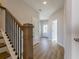 Hallway with wood floors, staircase, doors, and lots of natural light at 1996 Deco Dr, Kennesaw, GA 30144