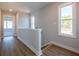 Hallway with wood floors, white trim, and natural light at 1996 Deco Dr, Kennesaw, GA 30144