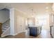 Open-concept kitchen with a center island, pendant lighting, and hardwood floors at 1996 Deco Dr, Kennesaw, GA 30144