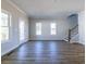 Open living room boasting wood floors, lots of windows, and staircase at 1996 Deco Dr, Kennesaw, GA 30144