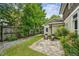Cozy backyard retreat with stone patio, manicured lawn, and lush landscaping offering a serene outdoor space at 261 Elmira Ne Pl, Atlanta, GA 30307