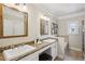 Bathroom featuring double sinks, granite countertops, and framed mirrors and a soaking tub at 261 Elmira Ne Pl, Atlanta, GA 30307