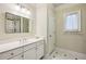 Clean and bright bathroom featuring a long countertop with a white sink and a shower at 261 Elmira Ne Pl, Atlanta, GA 30307