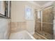 Tiled walk-in shower and jacuzzi tub in a bright bathroom with a window at 261 Elmira Ne Pl, Atlanta, GA 30307