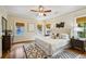 Bright bedroom featuring a bed, three windows, and a dresser at 261 Elmira Ne Pl, Atlanta, GA 30307