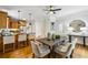 Open-concept kitchen and dining area with an inviting table and hardwood floors at 261 Elmira Ne Pl, Atlanta, GA 30307