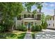 Charming two-story home with brown shingle and light-green siding, complemented by a well-manicured front yard at 261 Elmira Ne Pl, Atlanta, GA 30307