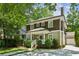 Charming two-story house with brown shingle and light-green siding, showcasing well-maintained landscaping at 261 Elmira Ne Pl, Atlanta, GA 30307