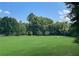Expansive green space with manicured lawn surrounded by mature trees, ideal for outdoor activities and recreation at 261 Elmira Ne Pl, Atlanta, GA 30307