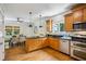 Well-lit kitchen with hardwood floors, stainless steel appliances and a view into the dining room at 261 Elmira Ne Pl, Atlanta, GA 30307