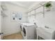 Clean laundry room with a washing machine, dryer, sink, and shelving at 261 Elmira Ne Pl, Atlanta, GA 30307