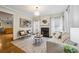 Cozy living room featuring a fireplace, neutral furnishings, and an open doorway to the kitchen at 261 Elmira Ne Pl, Atlanta, GA 30307