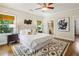 Comfortable bedroom featuring a ceiling fan, decorative rug, and natural light from two windows at 261 Elmira Ne Pl, Atlanta, GA 30307