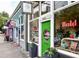 Vibrant retail storefront featuring a bright green door and inviting display windows filled with unique home decor items at 261 Elmira Ne Pl, Atlanta, GA 30307