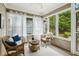 Cozy sunroom with wicker furniture, bright windows, and an outdoor view at 261 Elmira Ne Pl, Atlanta, GA 30307