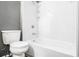 A clean white bathtub and toilet, showcasing the bathroom's simple design at 5575 Wells Circle, Stone Mountain, GA 30087