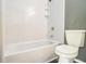 Bright bathroom featuring a sleek white bathtub, shower and toilet, offering a clean and modern space at 5575 Wells Circle, Stone Mountain, GA 30087