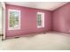 A bright bedroom featuring carpet flooring and two windows for natural light at 5575 Wells Circle, Stone Mountain, GA 30087