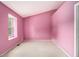 A cozy bedroom with pink walls, carpet flooring, and ample natural light at 5575 Wells Circle, Stone Mountain, GA 30087