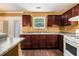 Kitchen showcasing granite countertops, hardwood floors, stainless steel appliances, and ample cabinet space at 5575 Wells Circle, Stone Mountain, GA 30087