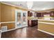 Bright dining area and kitchen boasting hardwood floors, modern light fixture, and patio access at 5575 Wells Circle, Stone Mountain, GA 30087