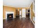Spacious living room features beautiful hardwood floors, fireplace, and open layout to dining area and kitchen at 5575 Wells Circle, Stone Mountain, GA 30087