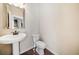 Neat powder room with pedestal sink and wood-look flooring at 6404 Brookside Se Blvd, Mableton, GA 30126