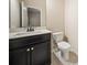 This is a well-lit bathroom with dark cabinets, a large mirror and white countertops at 6404 Brookside Se Blvd, Mableton, GA 30126