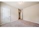 This is a standard sized bedroom with neutral walls and carpeting and an open closet at 6404 Brookside Se Blvd, Mableton, GA 30126