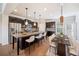Bright dining area featuring a sliding door, modern lighting fixtures, and hardwood flooring at 6404 Brookside Se Blvd, Mableton, GA 30126