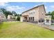 Spacious backyard featuring a well-manicured lawn, patio area, and a charming fence for added privacy at 1998 Lakeview Bend Way, Buford, GA 30519
