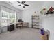 Brightly lit bedroom with large window, ceiling fan and a work desk with shelves at 1998 Lakeview Bend Way, Buford, GA 30519