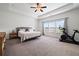 Spacious bedroom features a large window and tray ceiling at 1998 Lakeview Bend Way, Buford, GA 30519