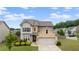 Charming two-story home with stone accents, a well-manicured lawn, and a two-car garage at 1998 Lakeview Bend Way, Buford, GA 30519