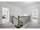 Upstairs hallway features neutral walls and carpet with doors to multiple rooms at 1998 Lakeview Bend Way, Buford, GA 30519
