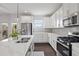 Modern kitchen features stainless steel appliances and center island at 1998 Lakeview Bend Way, Buford, GA 30519