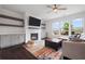 Cozy living room features built-in cabinets, a fireplace, and lots of natural light at 1998 Lakeview Bend Way, Buford, GA 30519