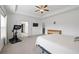 Bright main bedroom with a tray ceiling, ceiling fan, TV, and stationary bike at 1998 Lakeview Bend Way, Buford, GA 30519