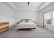 A bright main bedroom features a large bed with gray headboard under a tray ceiling at 1998 Lakeview Bend Way, Buford, GA 30519