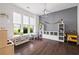 Spacious playroom with large windows, custom storage, and durable hardwood floors at 1998 Lakeview Bend Way, Buford, GA 30519